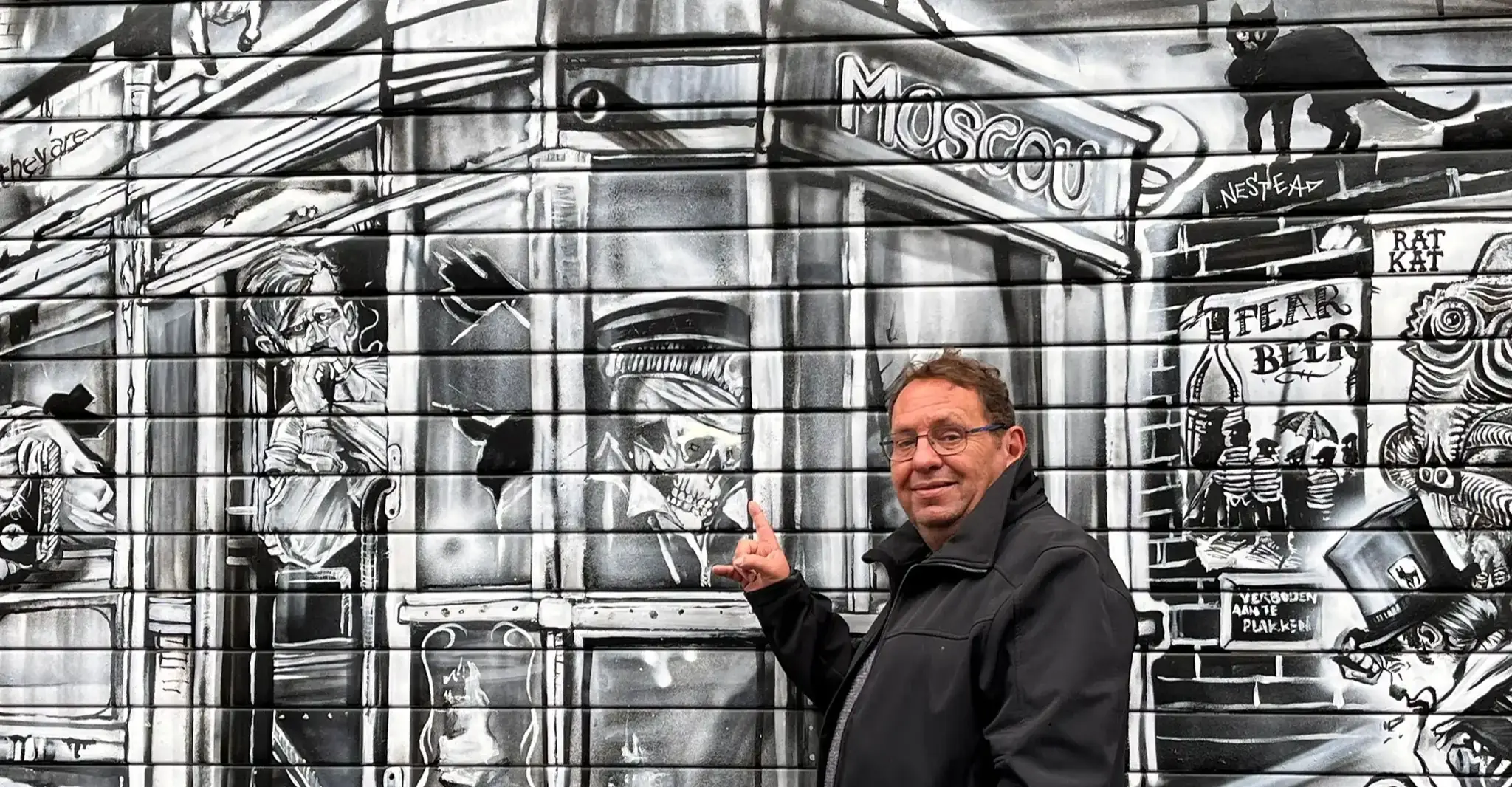 Marcel in front of an spray artwork